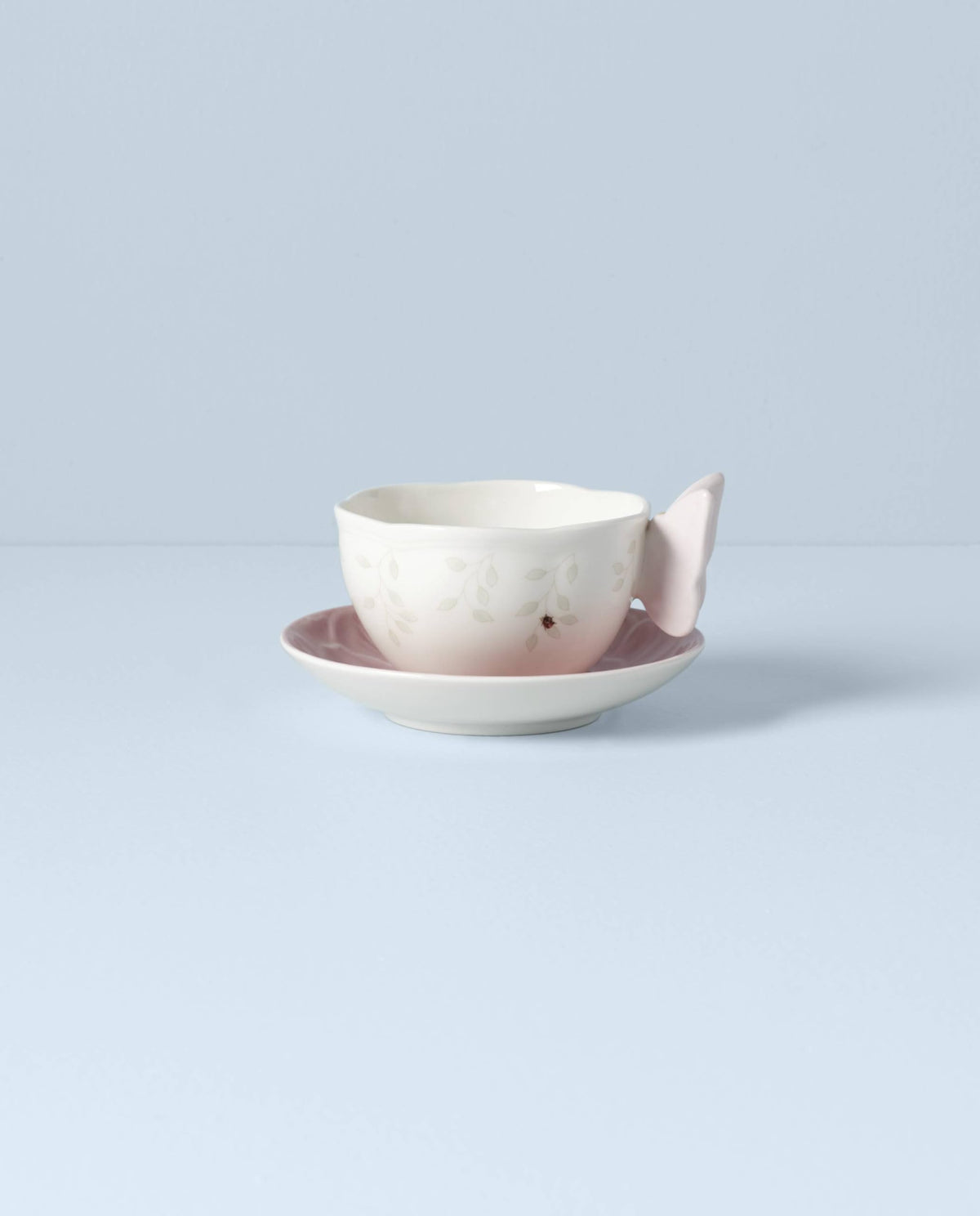 Butterfly-shaped handle on a pink porcelain cup