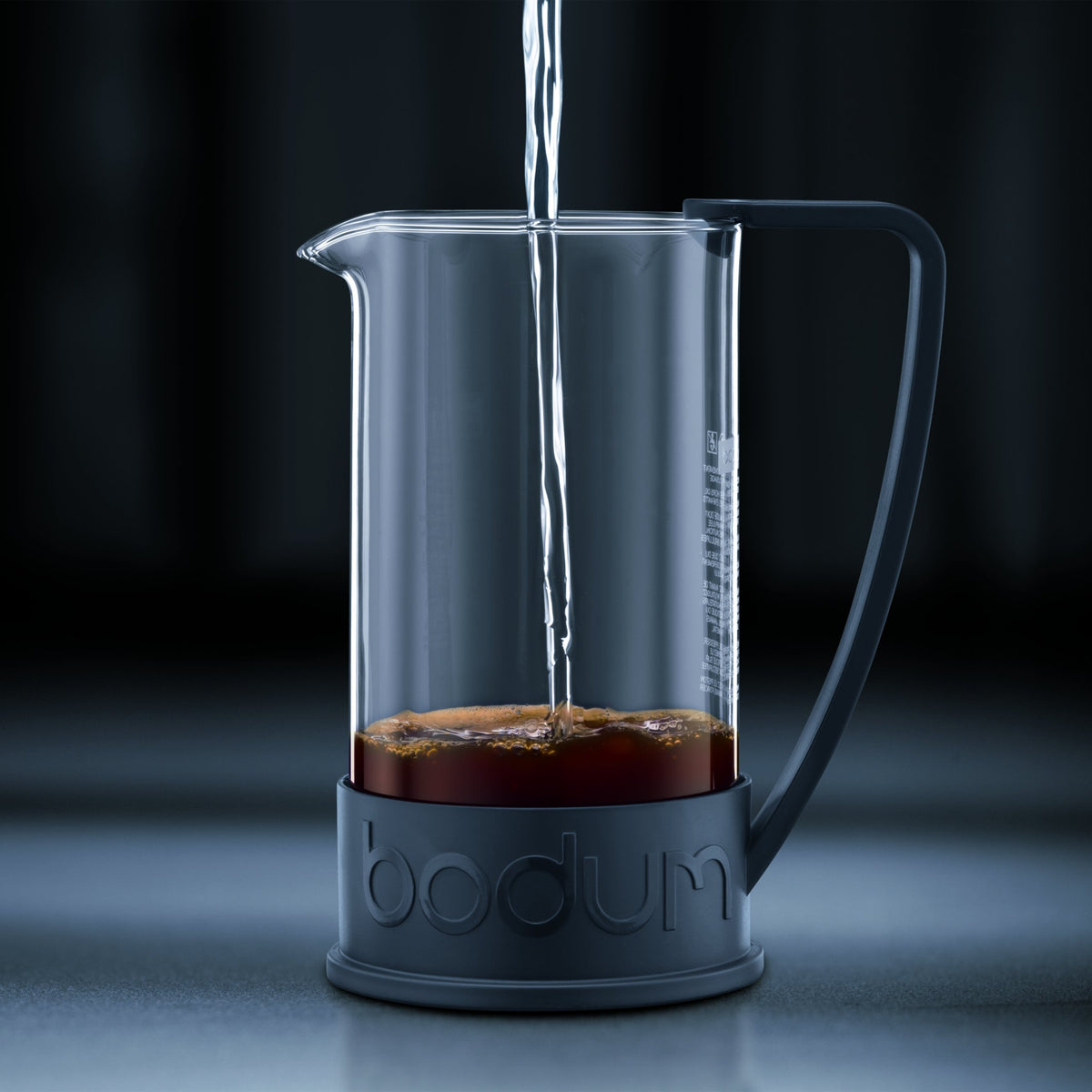 French press coffee maker showing red handle and base
